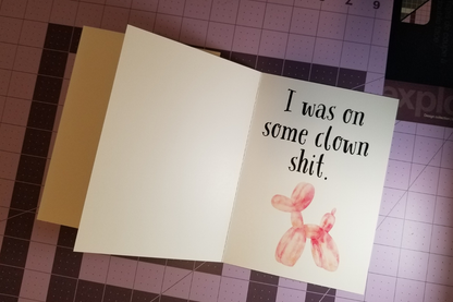 Card with balloon dog illustration and text on a cutting mat.
